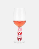 Set de 6 marque-verres Balvi Coquette en plastique PVC colorés, forme de nœuds pour identifier facilement chaque verre.