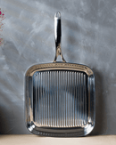 Détail des rainures du gril Cristel pour saisir viandes, légumes et poissons.