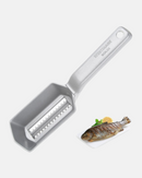 Écailleur Scalex Westmark avec récipient collecteur ouvert, prêt à recueillir les écailles de poisson.