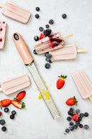 Zesteur Premium Classic Microplane placed among fruit popsicles, featuring vibrant berries and a fresh zest.